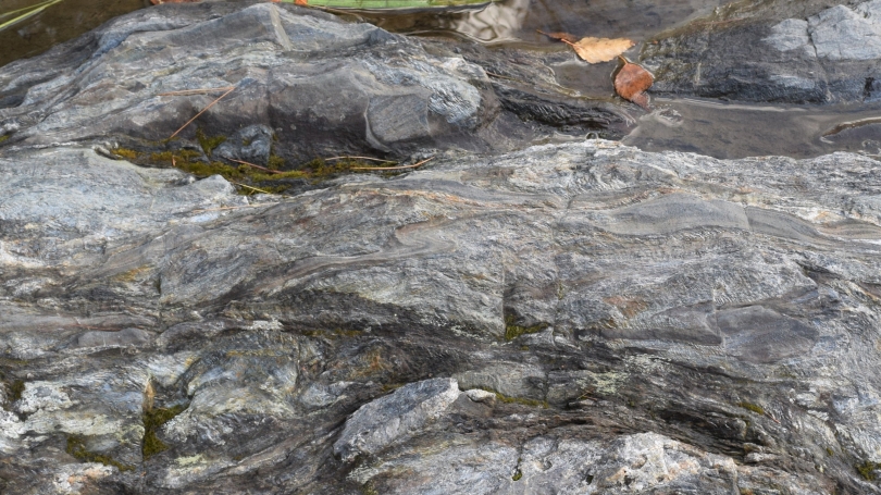 A high-resolution image used in the class "EARS1: How the Earth Works" shows how geologic activity can turn layers of mud and sand into metamorphic rocks. Over the past 14,000 years, the Ottauquechee River carved through this rock to create Vermont's Quec