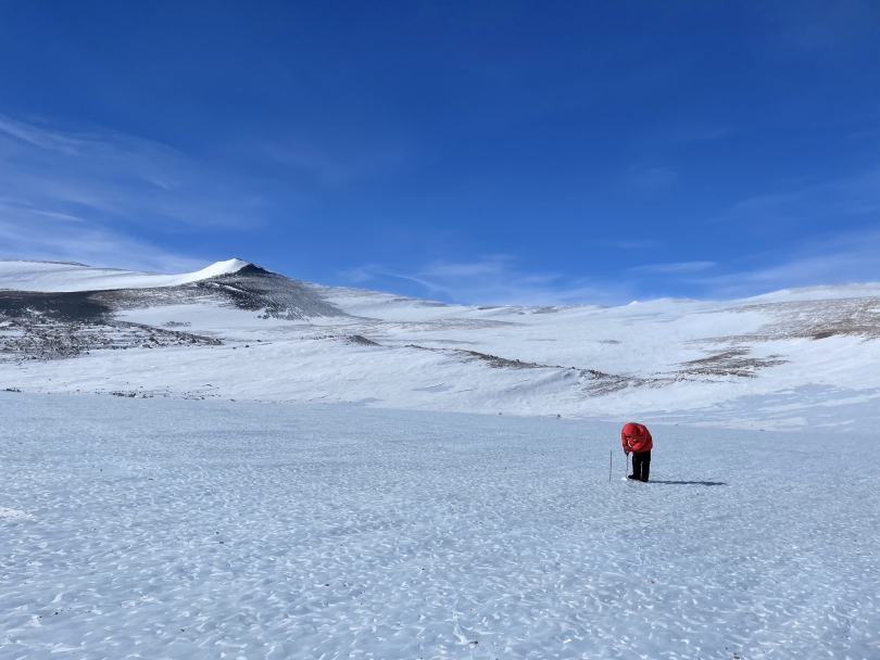 A researcher starting to drill for ice samples