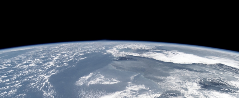 a partial photograph of earth from orbit showing the curvature of the planet